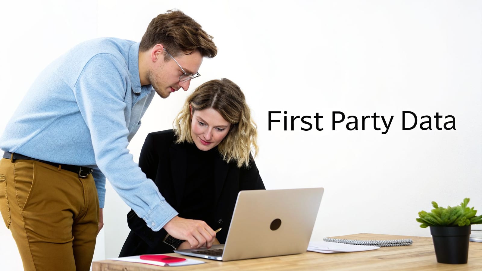 A man and woman collaborate on a laptop, with 'First Party Data' text beside them.